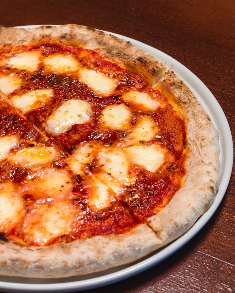Wood-fired margherita pizza fresh from the oven